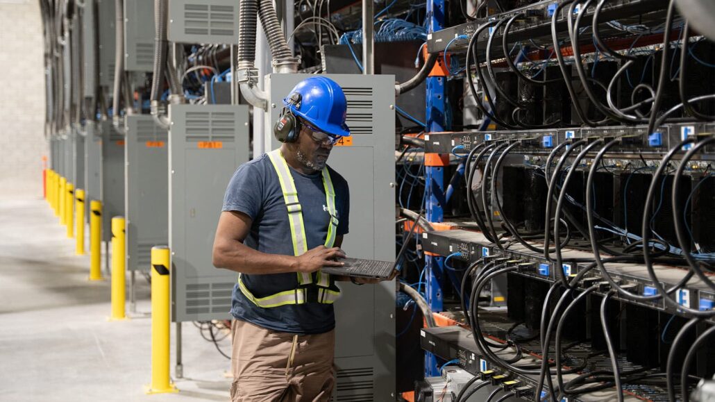 Bitfarms worker with laptop